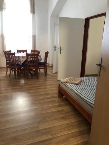 a room with a bed and a table and chairs at Apartmány Pražská in Ústí nad Labem