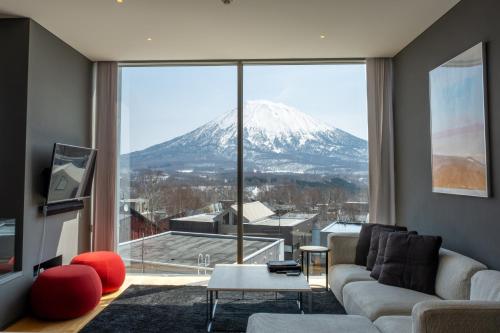 a living room with a view of a snow covered mountain at Terrazze in Kutchan
