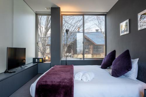 a bedroom with a large bed and a large window at Terrazze in Niseko