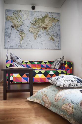 a living room with a couch and a map on the wall at The Nook Hostel in Ponta Delgada
