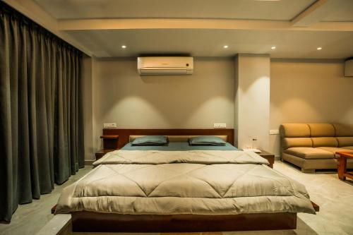 a bedroom with a large bed and a couch at Aarna studio in Jaipur