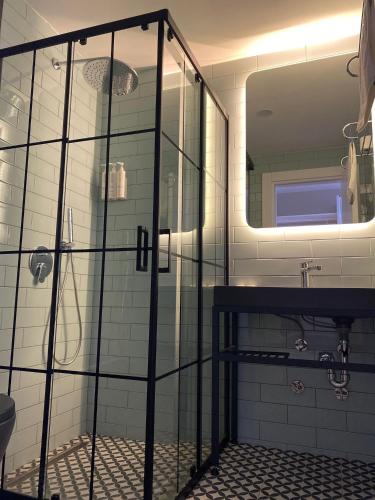 a bathroom with a shower and a sink and a mirror at KUCA URLA in Urla