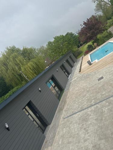 a house with a swimming pool on top of it at le chant de la rivière in Abbeville