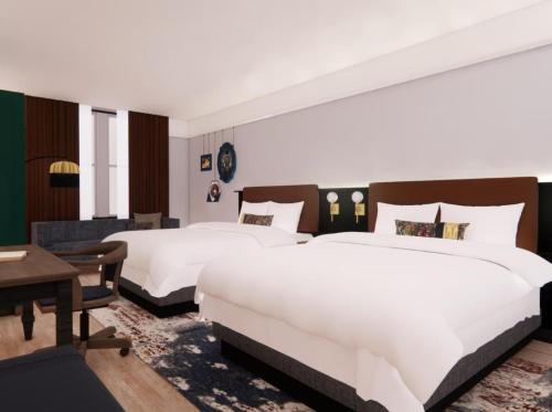 a hotel room with two beds and a desk at Hotel Indigo West Chester - Downtown by IHG in West Chester