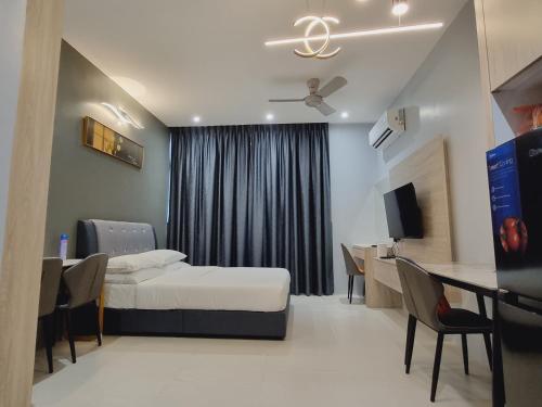 a hospital room with a bed and a table and chairs at Simple Nice Stay @ Riverine Diamond Petanak in Kuching