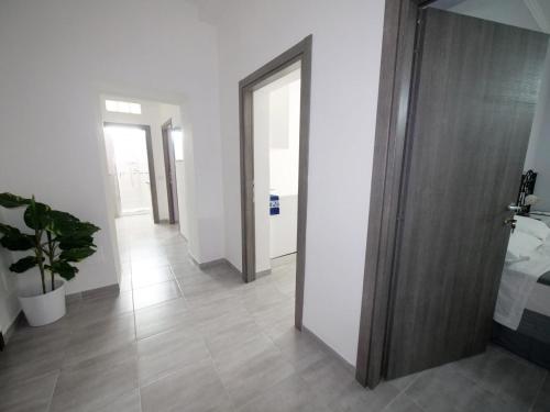 a hallway with white walls and a wooden door at Beb Da Tina in Roccasecca