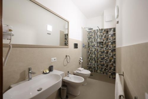 a bathroom with a sink and a toilet and a mirror at Hotel Villa Cute - HVC in Lipari