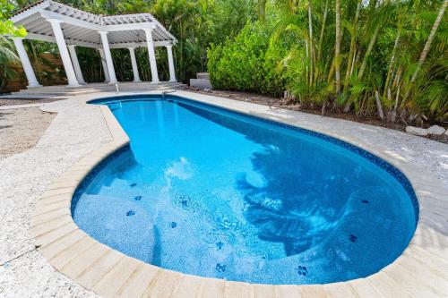 a large blue swimming pool with a gazebo at Crescent Beach Villas in Siesta Key