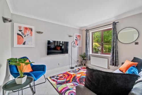 a living room with a couch and a table at The Pondmore-Spacious Detached house in Ashford with free parking close to M20 in Kent