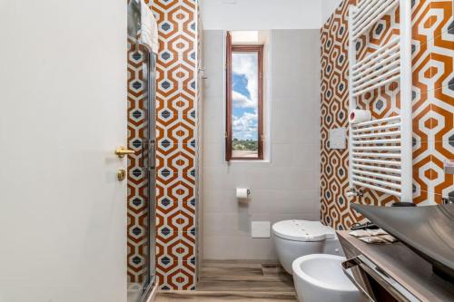 a bathroom with a toilet and a sink at Villa D'Aprile Exclusive Luxury Villa with pool, Jacuzzi, SPA in Castellana Grotte