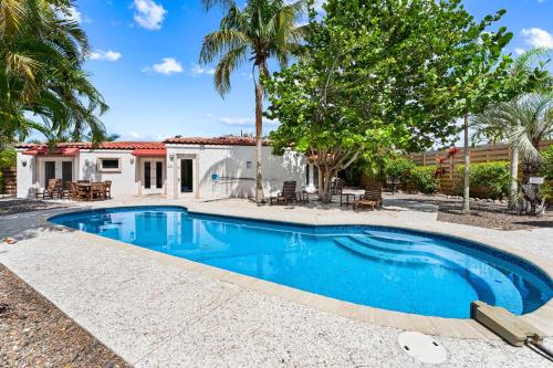 a swimming pool in front of a house at Crescent Beach Villas By Beachside Management in Siesta Key