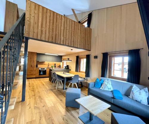 a living room with a blue couch and a table at Appartements Zur Post in Gries im Sellrain