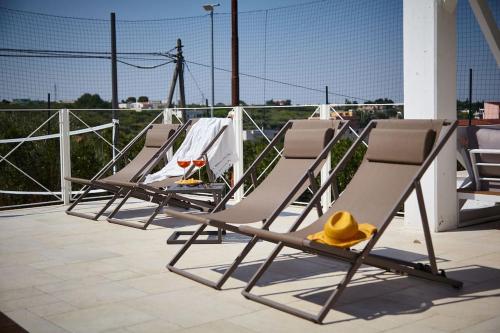 a group of lounge chairs sitting on a patio at Villa D'Aprile Exclusive Luxury Villa with pool, Jacuzzi, SPA in Castellana Grotte