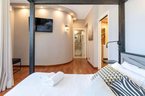 a bedroom with a bed with a television on the wall at Villa D'Aprile Exclusive Luxury Villa with pool, Jacuzzi, SPA in Castellana Grotte