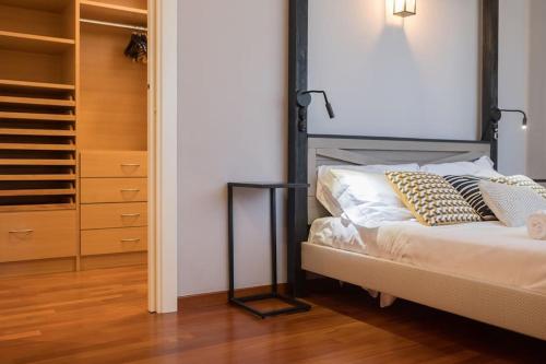 a bedroom with a bed and a closet at Villa D'Aprile Exclusive Luxury Villa with pool, Jacuzzi, SPA in Castellana Grotte