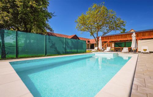 a swimming pool with a fence around it at Stunning Home In Ivanska in Ivanska