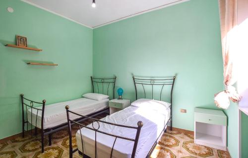 two beds in a room with blue walls at Cozy Apartment In Perdifumo With Wifi in Perdifumo
