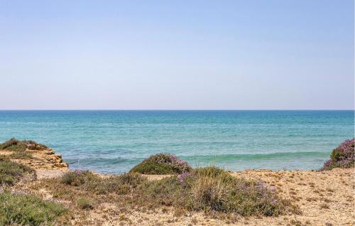 a view of the ocean from a sandy beach at Cozy Apartment In Perdifumo With Wifi in Perdifumo