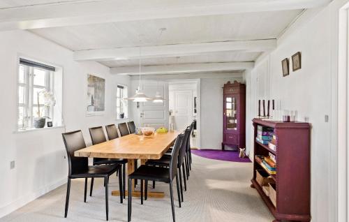 a dining room with a wooden table and chairs at 5 Bedroom Beautiful Home In Humble in Humble