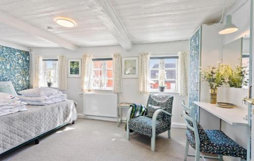 a bedroom with a bed and a desk and chairs at 5 Bedroom Beautiful Home In Humble in Humble