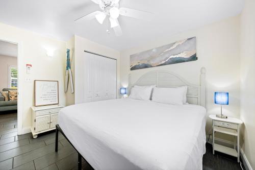 a white bedroom with a large bed and a couch at Gulf Holiday in Siesta Key