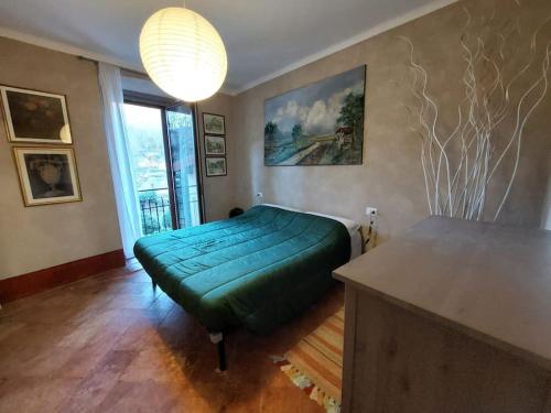a bedroom with a large green ottoman in a room at Casa Pedrarias in Lavena Ponte Tresa