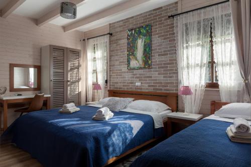 a bedroom with two beds with towels on them at Apartmani Ivanka in Rakovica