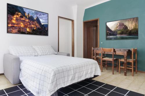 a bedroom with a bed and a table and a desk at Casa Dolce Casa - Centro Storico in Como