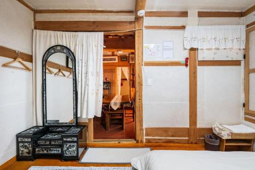 a bedroom with a mirror and a bed and a mirror at NamHyunDang - Hanok Korean Traditional House in Seoul