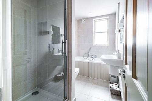 y baño con ducha, aseo y lavamanos. en White Horses - Sleeps 2 by Big Skies Cottages, en Blakeney