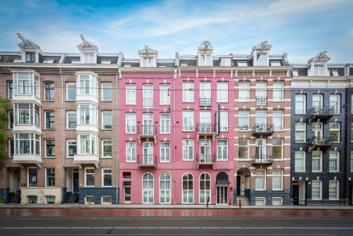 a pink building on the side of a street at Krisotel in Amsterdam