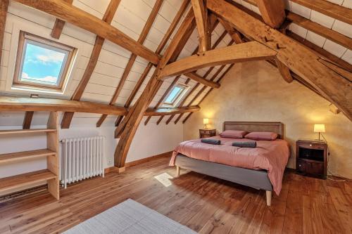 a bedroom with a bed in a room with wooden ceilings at Ty Forn - Maison à 10min des plages in Plougastel-Daoulas