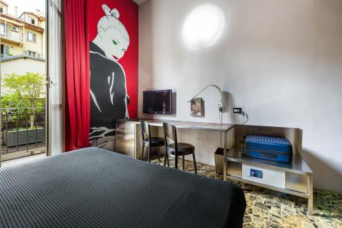 a hotel room with a bed and a desk with a computer at Art Hotel Boston in Turin