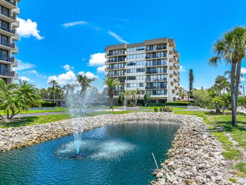 a fountain in a park in front of a building at Our House at the Beach 501W By Beachside Management in Siesta Key
