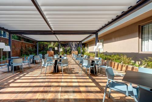 a patio with tables and chairs in a building at Art Hotel Boston in Turin