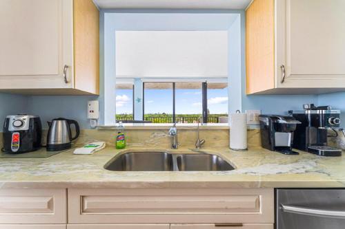 a kitchen counter with a sink and a window at Our House at the Beach 502E By Beachside Management in Siesta Key