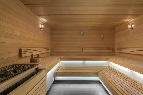 a sauna with wooden walls and wooden floors and benches at Porto Angeli in Archangelos