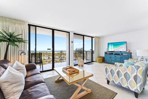 a living room with a couch and a table at Our House at the Beach 604E By Beachside Management in Siesta Key