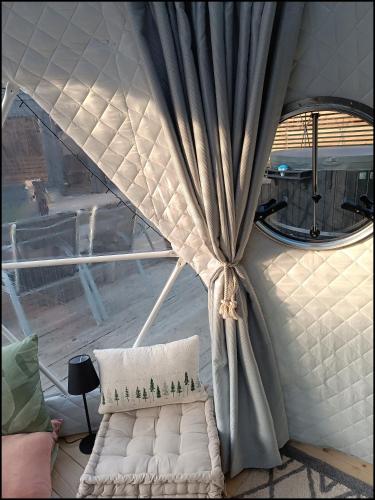 a white couch in a room with a curtain at Casa Vacanze Borc dai Cucs in Faedis