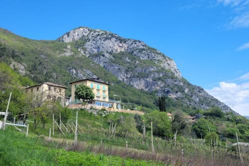 a house on a hill in front of a mountain at Hotel Panorama in Riva del Garda