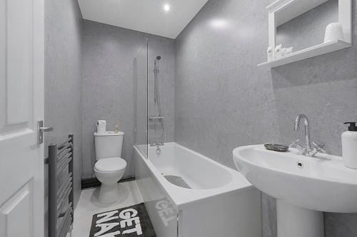 a white bathroom with a sink and a toilet at Frances Terrace Haven in Bishop Auckland