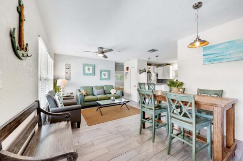 a kitchen and living room with a table and chairs at Sun and Sea By Beachside Management in Siesta Key