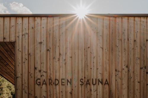 a wooden fence with the sun shining on it at VillaVerde Aparthotel in Lagundo