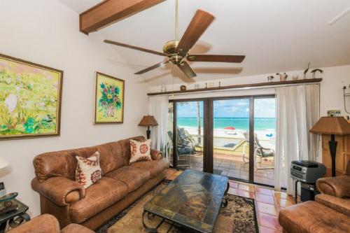 a living room with a couch and a ceiling fan at Fanta-Sea 47 By Beachside Management in Siesta Key
