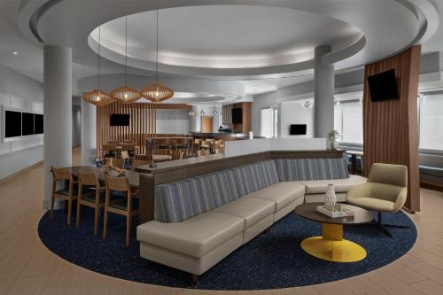 a living room with a couch and a bar at SpringHill Suites Houston Intercontinental Airport in Houston