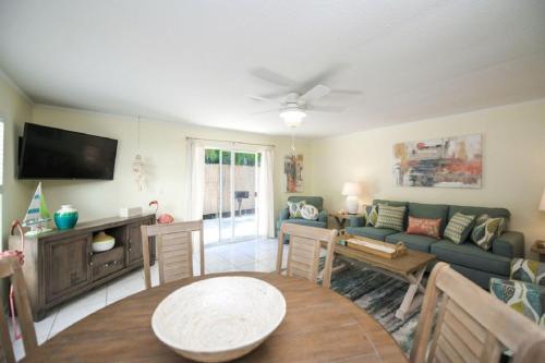 a living room with a couch and a table at Living the Dream By Beachside Management in Siesta Key
