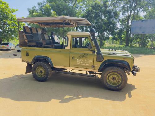 a green jeep parked on a dirt road at Harmony Haven, Udawalawe, Sri Lanka in Udawalawe