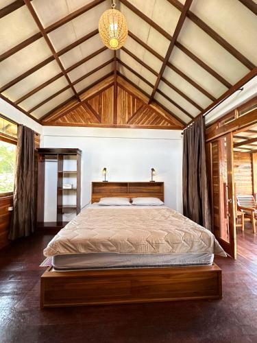 a bedroom with a large bed in a room at Bollata beach house in Gili Air