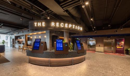 a exhibit in a building with a sign that says the reception at Citybox Helsinki in Helsinki