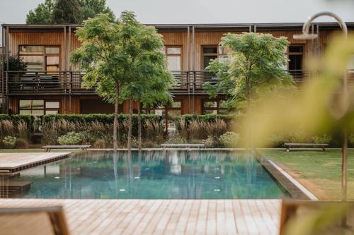 a swimming pool in front of a building at VillaVerde Aparthotel in Lagundo